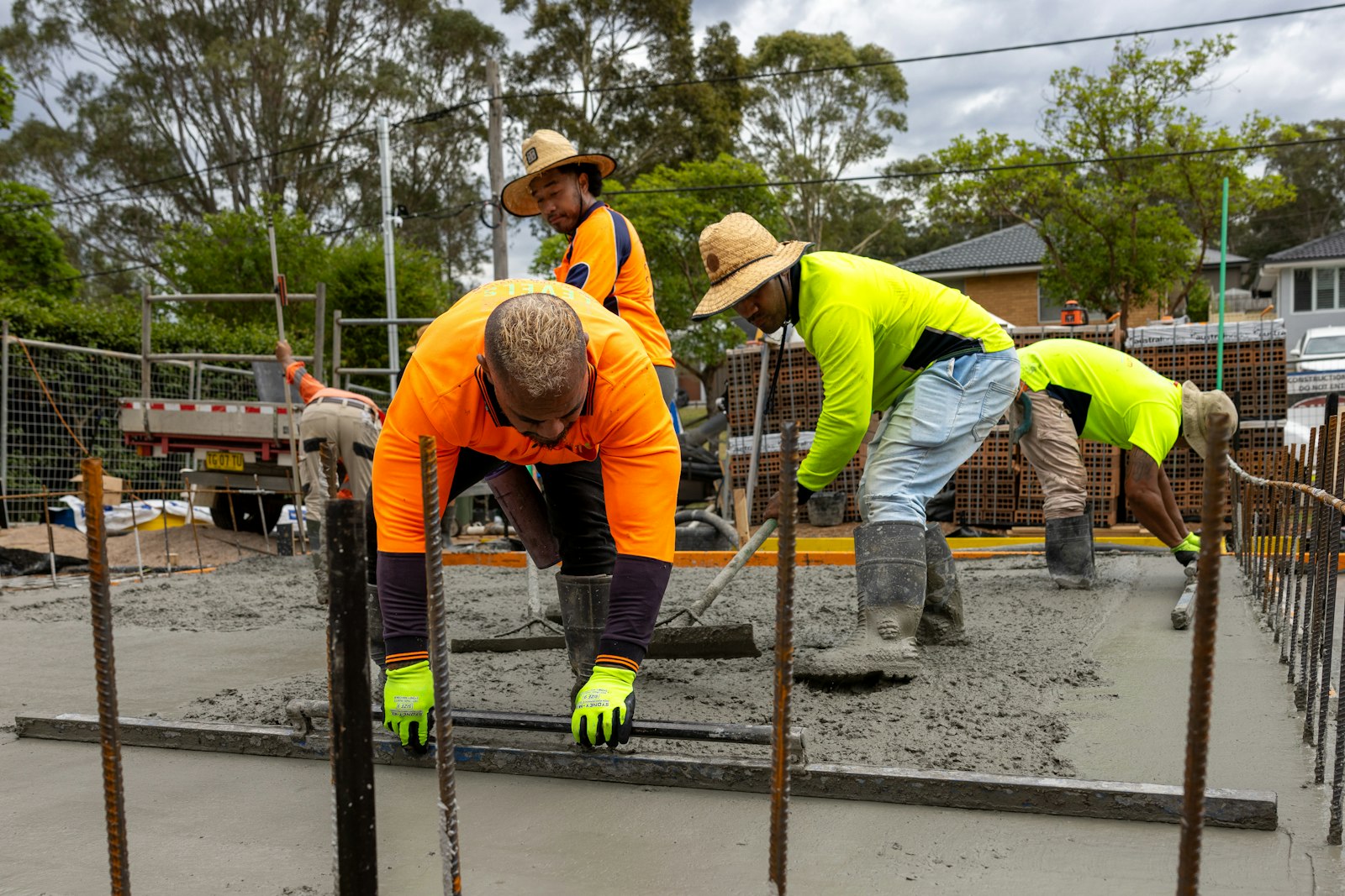 Crew pouring and leveling new concrete
